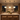 Three illuminated Aurelia Black pendants above a kitchen island at night