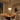 Illuminated Aurelia Black pendant in a warm Mediterranean dining room