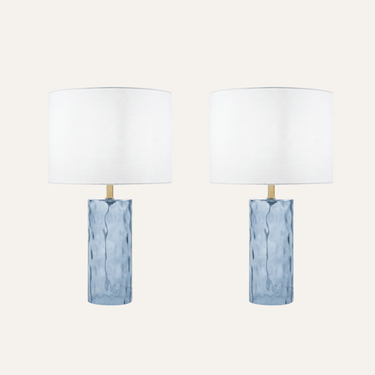 Deniz Glass Table Lamp Set of 2, featuring a wavy blue glass base and white shade in a coastal-inspired bedroom.