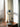 Halo I Chrome Table Lamp illuminated — warm 3000K glow through open chrome ring shade on nightstand