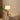 Lignis Table Lamp (white) on a side table next to a sofa in a cozy living room