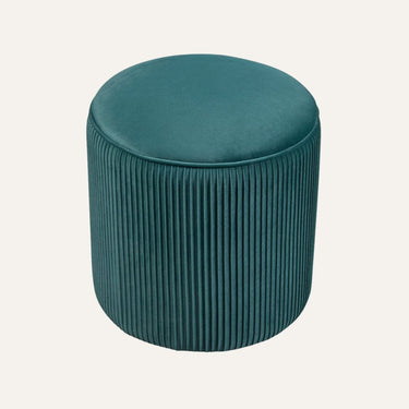 Quinn Ottoman in pumpkin orange velvet, pumpkin-shaped design in a modern living room setting.