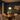 Illuminated Aurelia Gold schoolhouse pendant above a traditional dining table