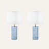 Deniz Glass Table Lamp Set of 2, featuring a wavy blue glass base and white shade in a coastal-inspired bedroom.