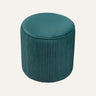 Quinn Ottoman in pumpkin orange velvet, pumpkin-shaped design in a modern living room setting.