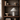 Alba fabric-covered table lamp displayed on a dark wood open shelf