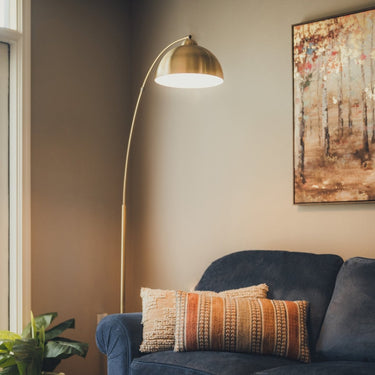 Venice Arc Floor Lamp with adjustable shade, antique brass finish, highlighting its sleek design and functionality.